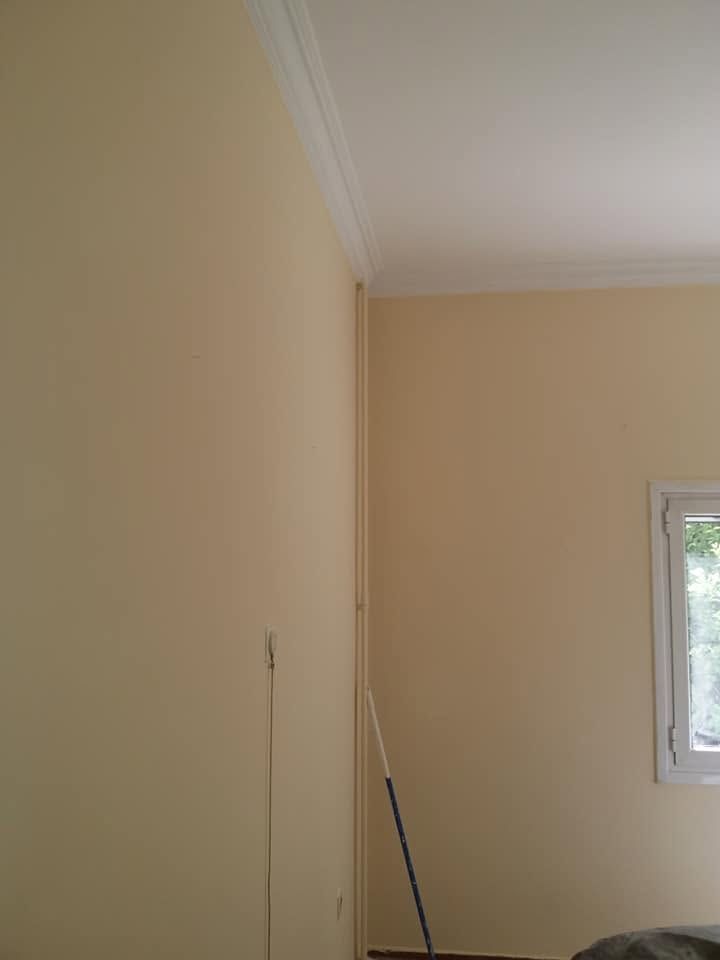 The bedroom walls in soft yellow