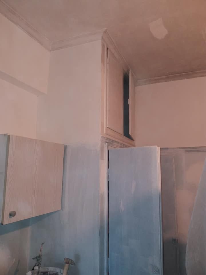 Preparing the walls around the cabinets