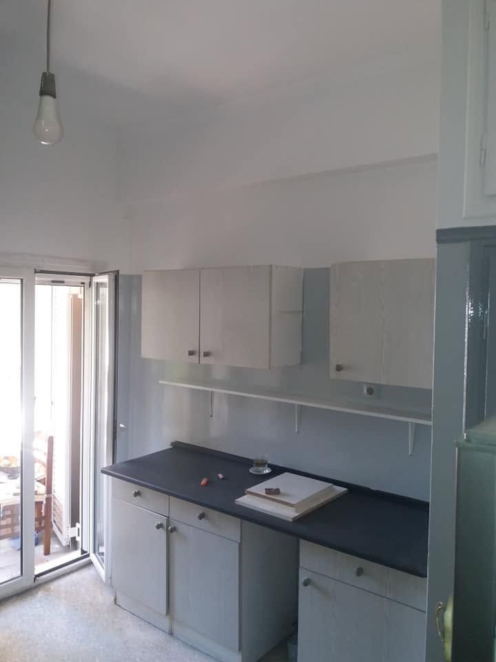 The kitchen with grey lower walls and white above