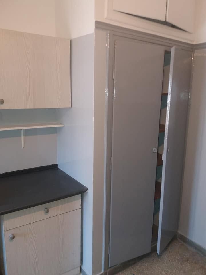 The tall cupboard painted grey