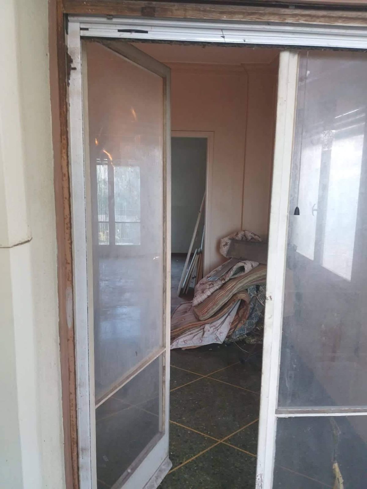 The living room before the work, seen through the glass doors