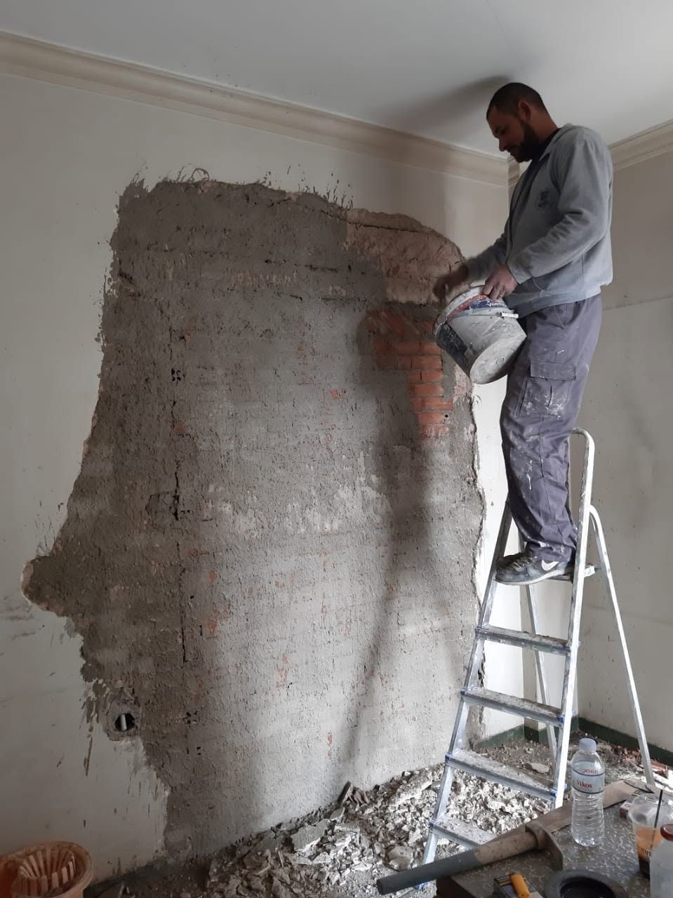 The first coat of plaster over the bricks