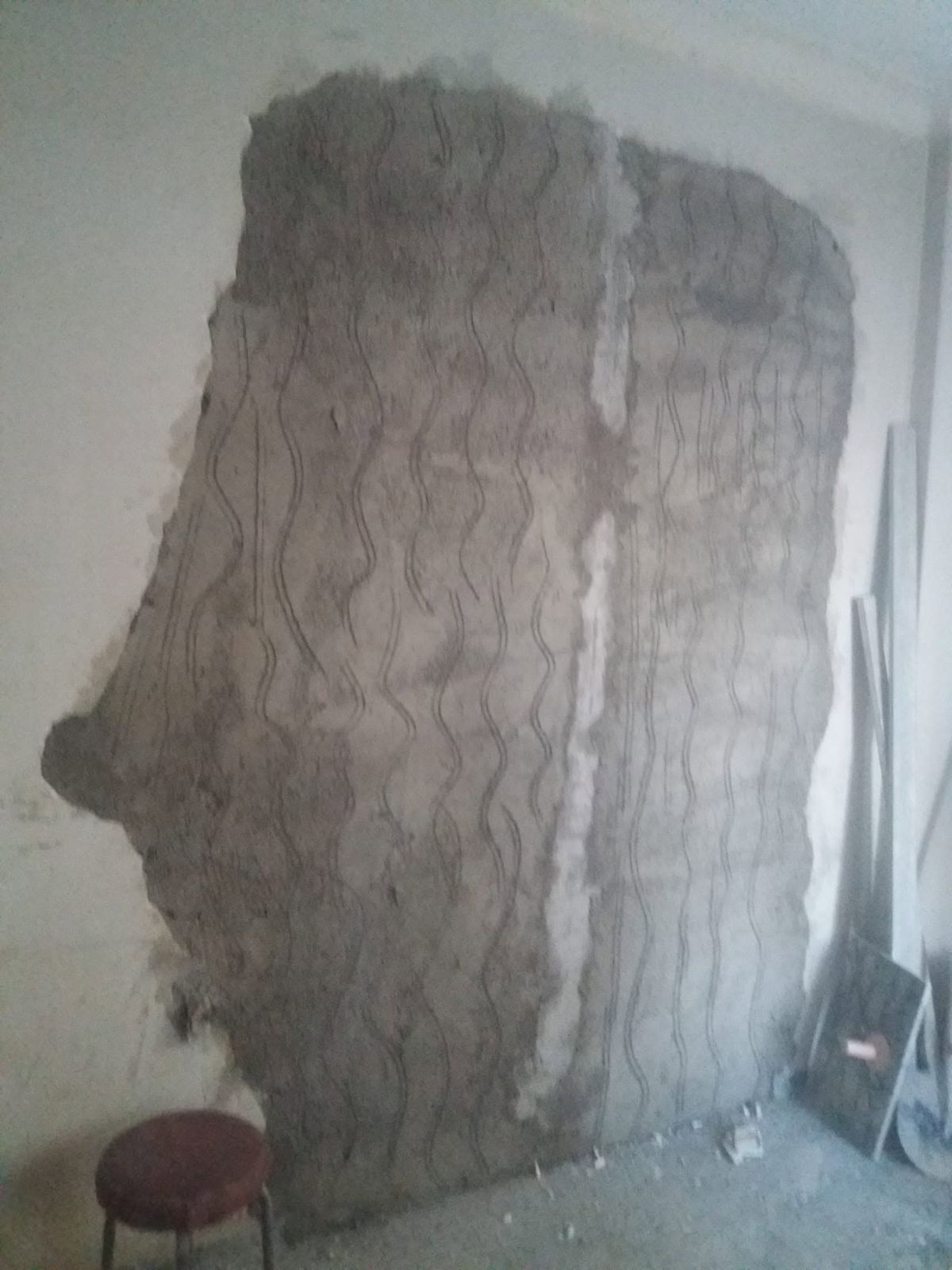 The bricked-up opening with its second coat of plaster