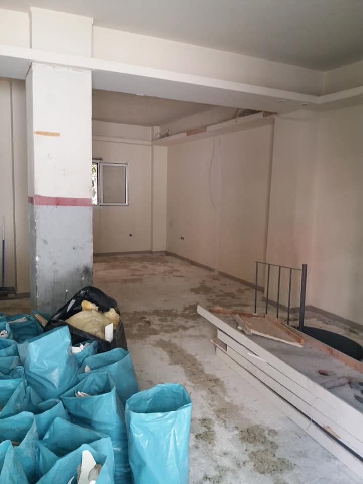 The empty space with a stained floor and bags