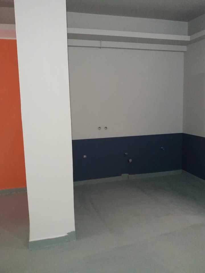 A wall with a dark blue band along the bottom