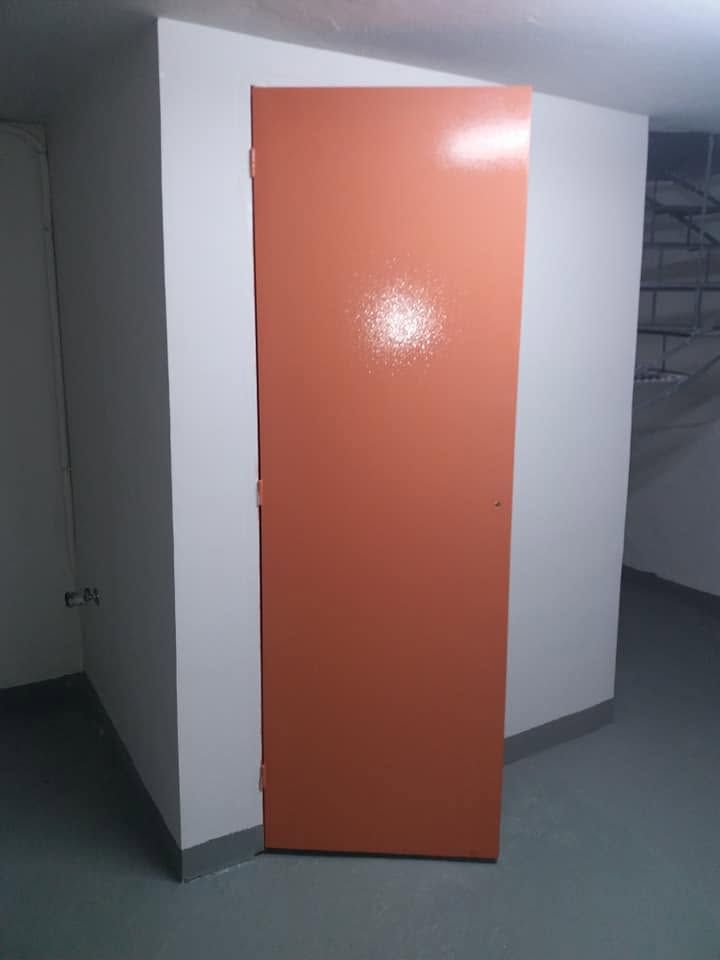 A toilet door painted orange