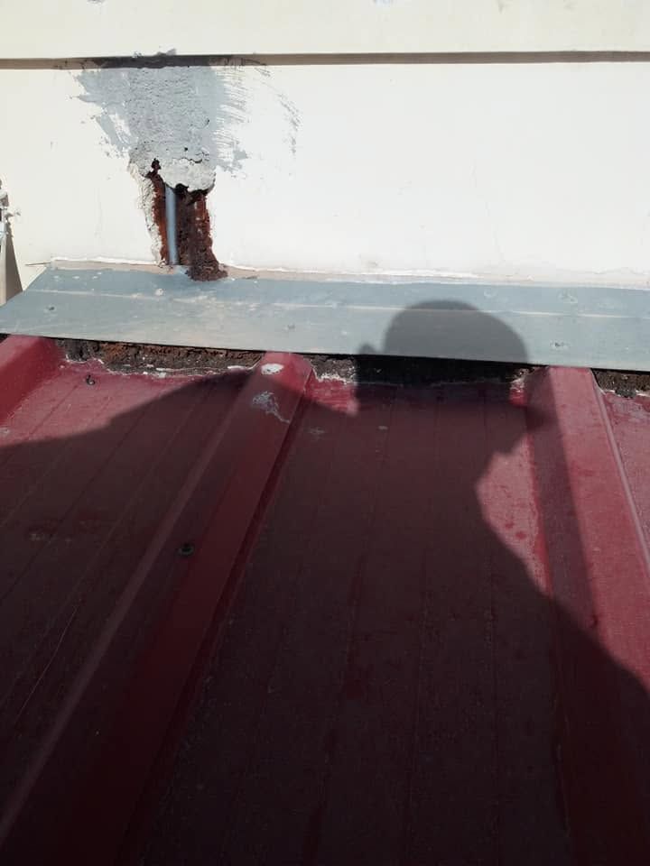 A broken spot in the wall above the flashing