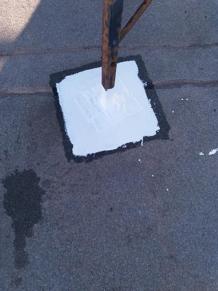 The post with a square of white waterproofing at its base